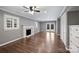 Bright living room with fireplace, plantation shutters, and hardwood floors at 1008 Dumbarton Rd, Gastonia, NC 28054