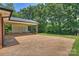 Spacious covered back patio perfect for outdoor entertaining with brick supports and concrete at 1008 Dumbarton Rd, Gastonia, NC 28054