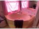 Bathroom with corner tub and mirrored wall at 1064 Calico Farm Ct, Cleveland, NC 27013