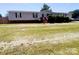Charming single-story home features a spacious front yard and inviting front porch at 1064 Calico Farm Ct, Cleveland, NC 27013