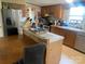 Kitchen with wood cabinets, modern appliances, breakfast bar, and adjacent dining area at 1064 Calico Farm Ct, Cleveland, NC 27013