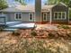 Spacious backyard with a large deck, brick patio, and mature landscaping at 11103 Fox Cove Dr, Charlotte, NC 28273