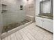 Bathroom with tiled shower, pebble floor, bench, and granite-topped vanity at 11103 Fox Cove Dr, Charlotte, NC 28273