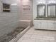 Modern bathroom featuring a dual sink vanity, a walk-in shower with bench seating, and updated fixtures at 11103 Fox Cove Dr, Charlotte, NC 28273