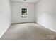 Bright bedroom with plush carpeting, natural light, and neutral color scheme at 11103 Fox Cove Dr, Charlotte, NC 28273