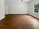 Spacious bedroom boasts hardwood flooring, bright window, and neutral walls at 11103 Fox Cove Dr, Charlotte, NC 28273