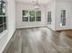 Bright dining area features wood-look floors, abundant natural light, and modern light fixture at 11103 Fox Cove Dr, Charlotte, NC 28273