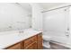 Functional bathroom with a wooden vanity, toilet, and tiled shower-tub combination at 11411 Ridge Oak Dr, Charlotte, NC 28273