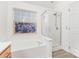 Bathroom with a soaking tub and a glass-enclosed shower at 11411 Ridge Oak Dr, Charlotte, NC 28273