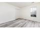 Cozy bedroom featuring wood-look flooring, closet, and a window offering lots of natural light at 11411 Ridge Oak Dr, Charlotte, NC 28273