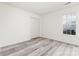 Cozy bedroom featuring wood-look flooring, closet, and a window offering lots of natural light at 11411 Ridge Oak Dr, Charlotte, NC 28273