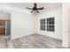 Bright dining room featuring a ceiling fan, large window, modern floors, and fresh, neutral paint at 11411 Ridge Oak Dr, Charlotte, NC 28273