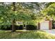 Charming single-story home with a brick facade, well-maintained lawn, and mature trees at 11411 Ridge Oak Dr, Charlotte, NC 28273