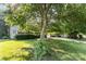 Well-maintained front lawn with mature shade trees and a view of the home at 11411 Ridge Oak Dr, Charlotte, NC 28273