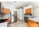 Bright kitchen featuring stainless steel appliances, wood cabinets, granite countertops, and mosaic backsplash at 11411 Ridge Oak Dr, Charlotte, NC 28273