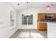 Bright kitchen with light wood cabinets, gray countertops, and a view of the yard at 11411 Ridge Oak Dr, Charlotte, NC 28273