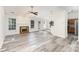 Inviting living room features a traditional fireplace, modern floors, and access to the backyard at 11411 Ridge Oak Dr, Charlotte, NC 28273