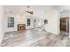 Inviting living room features a traditional fireplace, modern floors, and access to the backyard at 11411 Ridge Oak Dr, Charlotte, NC 28273