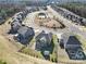 Aerial view of a neighborhood showcasing the community pool, manicured lawns, and quiet cul-de-sac streets at 1169 Hollis Sw Cir, Concord, NC 28025