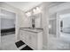 Bright bathroom featuring double vanity with granite countertop and modern fixtures at 1169 Hollis Sw Cir, Concord, NC 28025