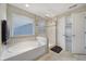 Bright bathroom featuring a tub and separate glass shower at 1169 Hollis Sw Cir, Concord, NC 28025