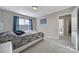 Bedroom featuring a queen bed, blue curtains, neutral walls and carpet, and natural light at 1169 Hollis Sw Cir, Concord, NC 28025