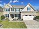Charming two-story home featuring a lush lawn, two-car garage and welcoming front porch at 1169 Hollis Sw Cir, Concord, NC 28025
