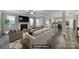 Staged living room with fireplace flowing into an open-concept white kitchen at 1169 Hollis Sw Cir, Concord, NC 28025