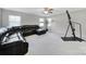 Living room with a black sofa, a fan, a plant, and an exercise machine at 1169 Hollis Sw Cir, Concord, NC 28025