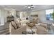 Staged living room with a neutral color palette, a cozy fireplace, and abundant natural light at 1169 Hollis Sw Cir, Concord, NC 28025