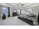 Primary bedroom featuring a tray ceiling, carpet, and large windows at 1169 Hollis Sw Cir, Concord, NC 28025