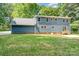 Exterior view of a blue house featuring a well-maintained lawn and mature trees at 133 Pecan Ln, Salisbury, NC 28146