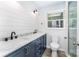 Bathroom features a modern vanity with double sinks and updated finishes with a window at 133 Pecan Ln, Salisbury, NC 28146