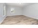 A bright bedroom with a window has wood flooring at 133 Pecan Ln, Salisbury, NC 28146