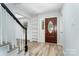 Bright entry featuring wood-look floors, white trim, and an inviting front door with decorative glass at 133 Pecan Ln, Salisbury, NC 28146
