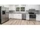 The kitchen with stainless steel appliances has a large window and a granite countertop at 133 Pecan Ln, Salisbury, NC 28146