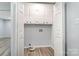 White cabinets in the laundry room offer storage with a dryer hookup at 133 Pecan Ln, Salisbury, NC 28146