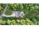 Stunning aerial view of a home with a large pool surrounded by lush greenery and a curved driveway at 146 Bullfinch Rd, Mooresville, NC 28117