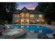 A backyard oasis features a sparkling pool, spa, and an open porch perfect for entertaining at 146 Bullfinch Rd, Mooresville, NC 28117