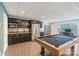 Basement bar area with sink, microwave, and fridge in rec room with pool table at 146 Bullfinch Rd, Mooresville, NC 28117
