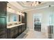Primary bathroom boasts double sink vanity with granite counters, custom cabinets and tile flooring at 146 Bullfinch Rd, Mooresville, NC 28117