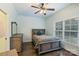 Comfortable bedroom with a ceiling fan, dresser, and a window bringing in natural light at 146 Bullfinch Rd, Mooresville, NC 28117