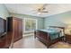 Cozy bedroom with a large window, ceiling fan and a hardwood floor at 146 Bullfinch Rd, Mooresville, NC 28117