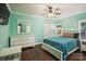 Inviting bedroom with white furnishings, a ceiling fan, and hardwood floors at 146 Bullfinch Rd, Mooresville, NC 28117