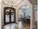 Inviting foyer with detailed millwork and hardwood flooring flows into the formal dining room at 146 Bullfinch Rd, Mooresville, NC 28117