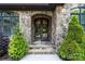 Elegant stone entryway features a gorgeous front door and lush greenery adding a touch of class at 146 Bullfinch Rd, Mooresville, NC 28117