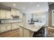Well-lit kitchen features a large island with seating and dining area beyond the granite counters at 146 Bullfinch Rd, Mooresville, NC 28117