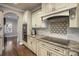 Granite counters and cooktop in a gourmet kitchen with custom backsplash and trim work at 146 Bullfinch Rd, Mooresville, NC 28117