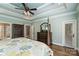 Primary bedroom featuring tray ceilings, a dresser, and large windows, creating a bright space at 146 Bullfinch Rd, Mooresville, NC 28117