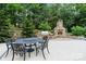 Outdoor dining area with a stone fireplace and built-in grill, ideal for entertaining at 146 Bullfinch Rd, Mooresville, NC 28117